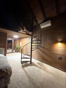 a spiral staircase in a room with a wall at Royal Ranch Nature Resort in Orhei