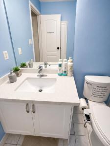 a bathroom with a white sink and a toilet at one bedroom in Brampton in Brampton +1 photo