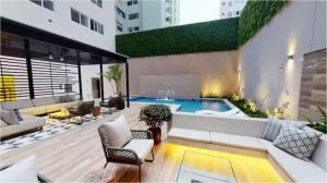a living room with a pool in a building at OceanFront Larcomar Apartments in Lima