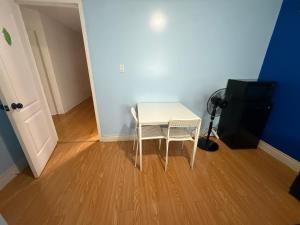 a small white table and two chairs in a room at one bedroom in Brampton in Brampton