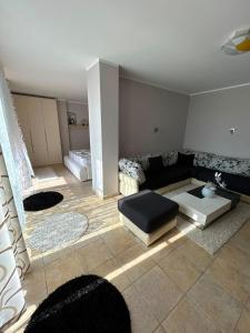 a living room with a couch and a table at Apartment golem in Durrës