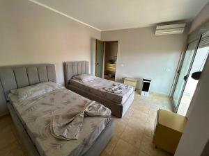 a bedroom with two beds in a room at Apartment golem in Durrës