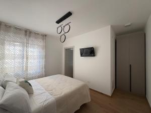 a bedroom with a bed and a clock on the wall at Colombo Boutique Rooms in Tortoreto Lido