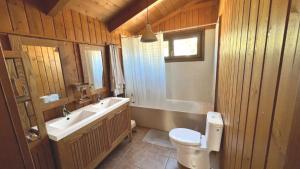 a bathroom with a toilet and a sink and a tub at Landscape Casa de Madera in Tarragona +23 photos
