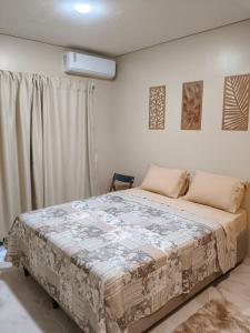 a bedroom with a large bed in front of a window at Hospedaria Lençóis in Barreirinhas