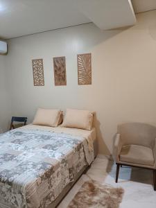 a bedroom with a bed and a chair at Hospedaria Lençóis in Barreirinhas +15 photos