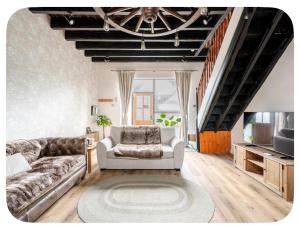 a living room with a couch and a television at The Hurst Stable Sleeps 4 with Hot Tub & Parking in Stafford