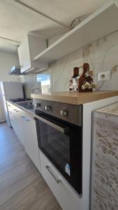 a kitchen with a stove and a counter top at Casa Vacanze Maurella in Marconia +29 photos