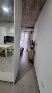 a living room with a table and a dining room at Apartment Z Alberdi Home in Belén de Escobar +3 photos
