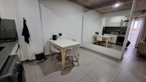 a kitchen and dining room with a table and chairs at Apartment Z Alberdi Home in Belén de Escobar