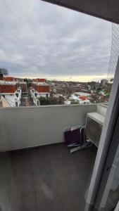 a balcony with chairs and a view of a city at Apartment Z Alberdi Home in Belén de Escobar