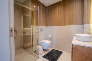 a bathroom with a shower and a toilet and a sink at Nautilus Villa - Private Pool II in Elaía +11 photos