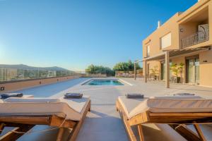 a villa with a swimming pool and two beds at Nautilus Villa - Private Pool II in Elaía