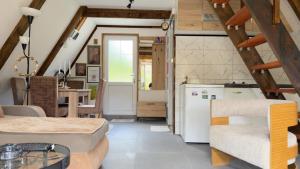 a kitchen and living room with a white refrigerator at Vrela Holiday Home in Cetinje
