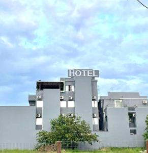 a hotel with a sign on the side of it at Hotel Guaíba in Guaíba