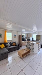 a living room with a couch and a table at Kaz alizé in Sainte-Marie