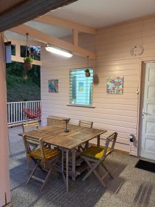 a wooden table and chairs on a patio at Kaz alizé in Sainte-Marie +10 photos