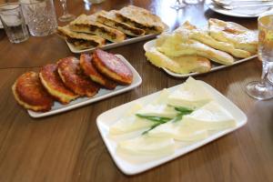 a table with four plates of food on it at Hotel - Old Ushguli in Ushguli