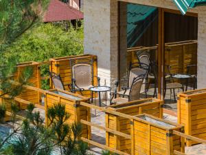 a group of chairs and tables on a patio at Brvnara Mont 1 in Zlatibor