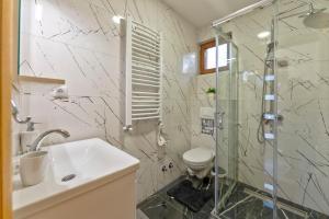 a bathroom with a shower and a sink and a toilet at Brvnara Mont 1 in Zlatibor +7 photos