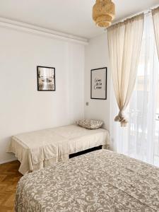a bedroom with two beds and a window at Gato street, Private rooms in Madrid
