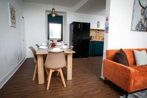 a living room with a table and a couch at Castle Grant - 4 Bed Cottage in Gardenstown in Gardenstown