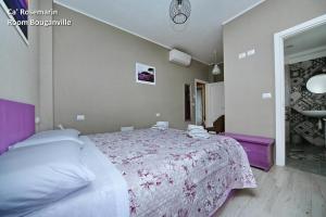 a bedroom with a large bed with a pink blanket at Ca' RoseMarin in Cogorno