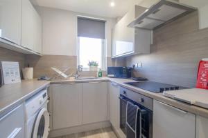 a kitchen with a sink and a dishwasher at Highfield Apartment- 2 Bed in Motherwell close to centre in Motherwell