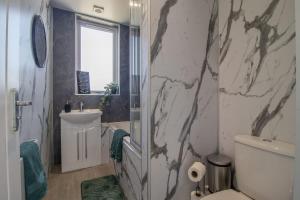 a bathroom with a toilet and a sink and a mirror at Highfield Apartment- 2 Bed in Motherwell close to centre in Motherwell +22 photos