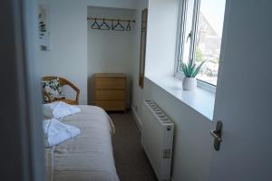 a bedroom with a radiator and a window at Park House - 3 bedroom in Portsoy +19 photos