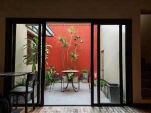 an open door to a patio with a table and potted plants at Hotel Urbana in Córdoba