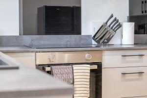 a kitchen with a stove with towels on the oven at Alexandra Apartment - Single Room #1 in Falkirk +15 photos