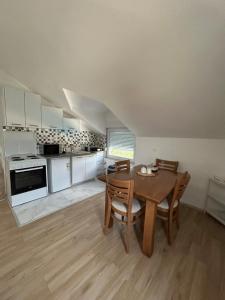 a kitchen and dining room with a table and chairs at Amra in Počitelj