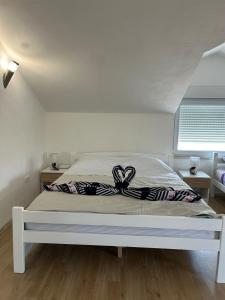 a white bed with a ribbon on it in a bedroom at Amra in Počitelj +20 photos