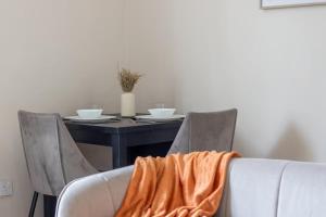 an orange blanket sitting on top of a table at Mitchell Apartment in Airdrie