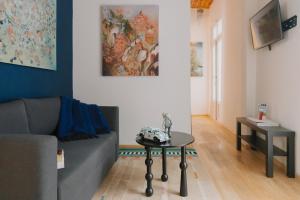 a living room with a couch and a table at Maximo Mexico Roma in Mexico City