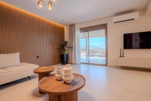 a living room with a couch and a table at Nautilus Villa - Private Pool II in Elaía