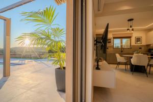 a house with a palm tree in a living room at Nautilus Villa - Private Pool II in Elaía