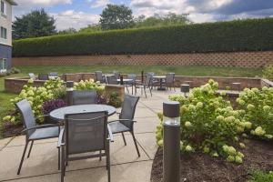 a group of tables and chairs in a garden at Fairfield by Marriott Frankfort in Frankfort