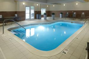a pool in a hotel room with chairs and a table at Fairfield by Marriott Frankfort in Frankfort