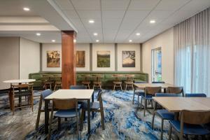 a dining room with tables and chairs in a building at Fairfield by Marriott Frankfort in Frankfort