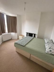 a bedroom with a bed and a window at The Nest Chelmsford in Chelmsford