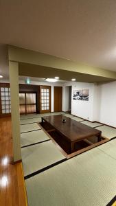 a large room with a table in the middle of it at さくらやゲストハウス in Tokushima