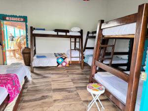 a room with four bunk beds and a table at El Rincón del Sol y Luna in Quimbaya