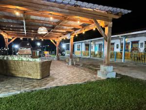 a patio under a wooden pergola at night at El Rincón del Sol y Luna in Quimbaya