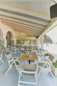 a group of chairs and tables on a patio at Kelly Hotel Agios Ioannis Pelion in Agios Ioannis Pelio