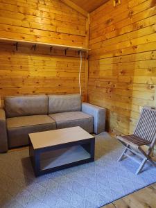 a living room with a couch and a table and a chair at Lada Bojana in Ulcinj