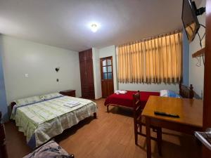 a bedroom with a bed and a desk and a table at Casa familiar D'Greta in San Ramón