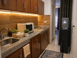 a kitchen with a sink and a microwave at New Coast Chalets -K77 in Dawwār Muḩammad Abū Shunaynah