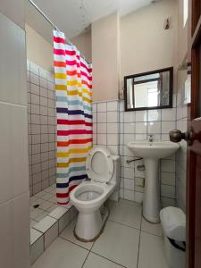 a bathroom with a toilet and a sink at Casa familiar D'Greta in San Ramón +7 photos